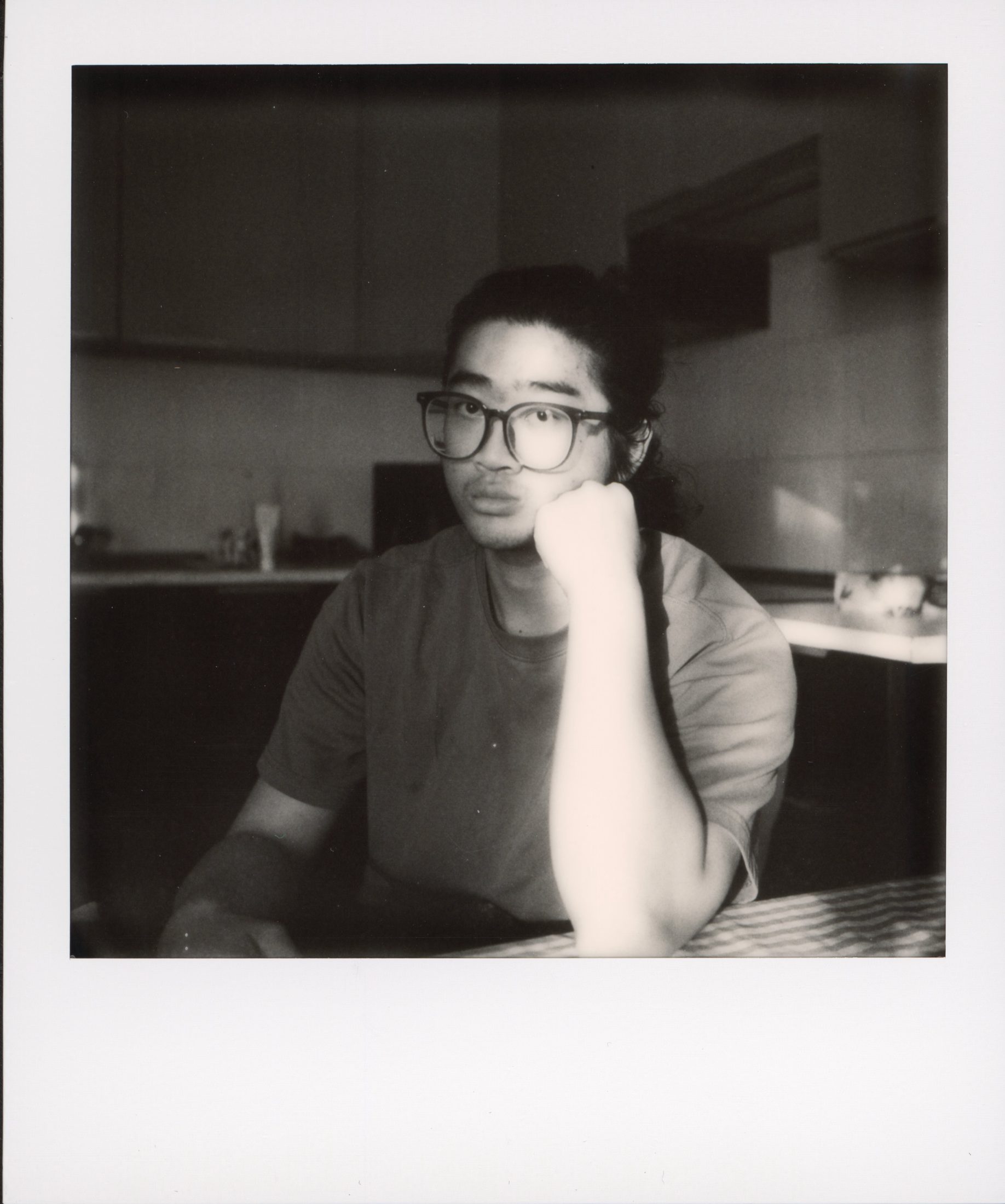 Black and white Polaroid portrait of Yizhou Wang